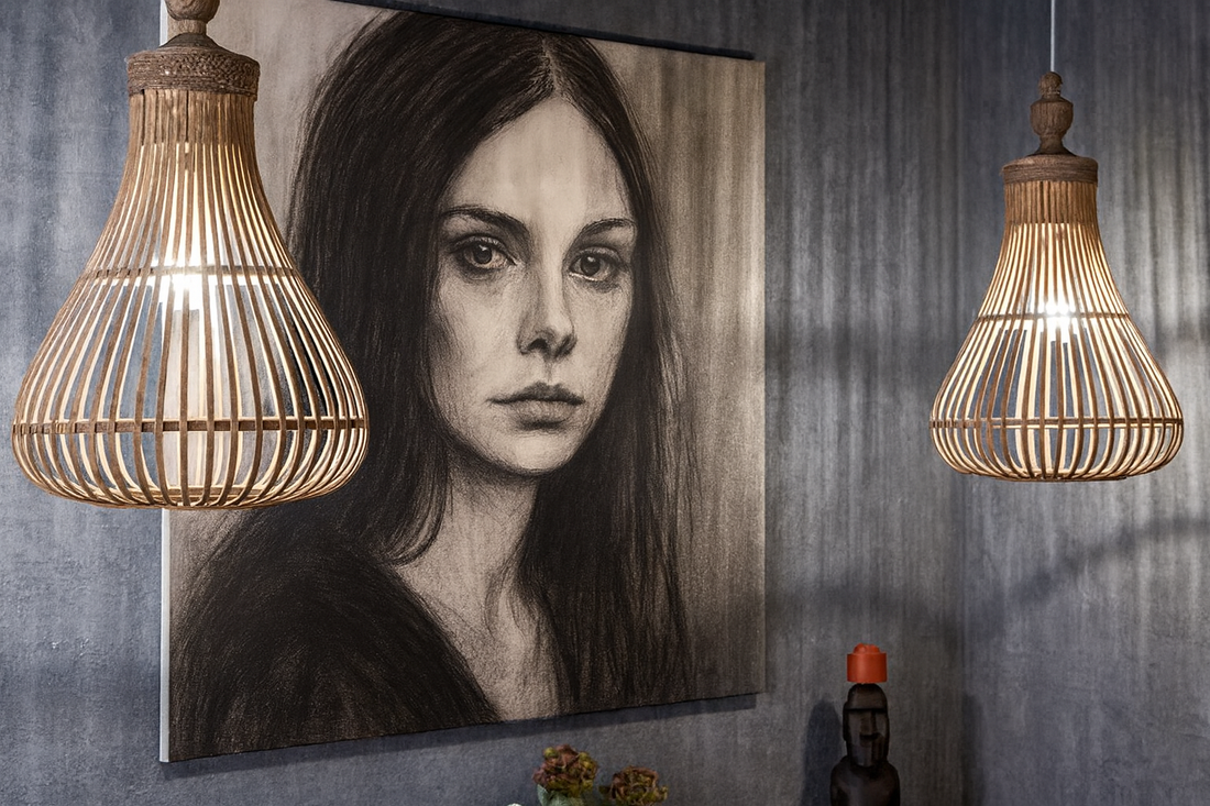 Stylish interior with a monochromatic female portrait in expressive shading, flanked by wicker pendant lights, set against a textured gray wall with sculptural accents — illustrating emotional realism in neo‑noir interior design.